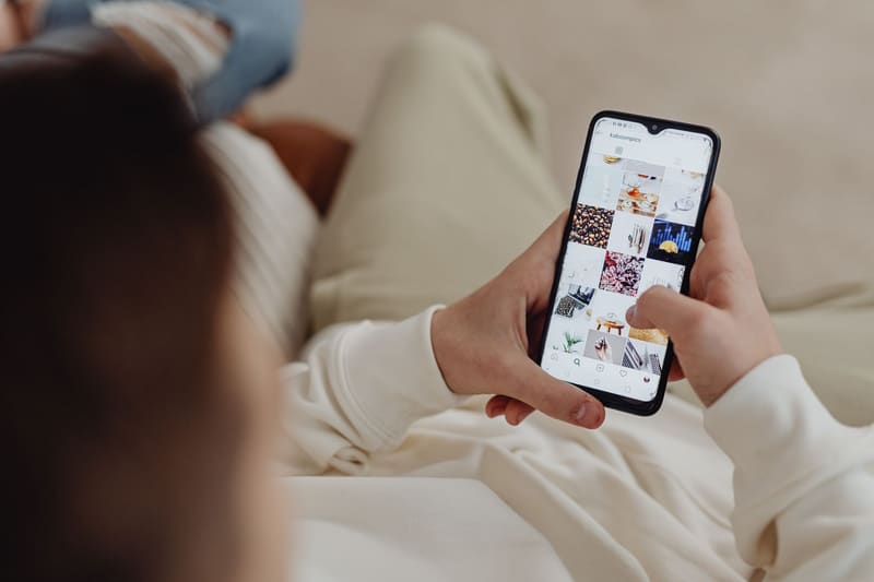 Persona viendo reels y publicaciones de Instagram en el móvil